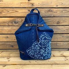 a blue backpack sitting on top of a wooden floor