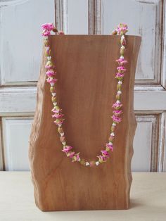 . 🪶 [ What You Will Receive]    1 piece  Handmade Rose and mini crown flower Lei with  Thai cotton cloth bag . 🪶 [ Material]   Rose bud and Crown flower made form Thai Clay  🪶 [Size & Color] Neck circumference : 31  inches  Color: Pink ,white  🪶 [Decoration Ideas] This Clay flower Lei is a handcrafted piece where each flower is individually molded by skilled craftsmen. You will experience the charm of handmade work that has a unique natural feel. Clay Flower Lei also goes well with any outfi Crown Flower Lei, Wedding Lei, Flower Lei, Mini Crown, Hawaiian Lei, Crown Flower, Handmade Rose, Clay Flower, Rose Bud