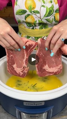 the woman is preparing raw meat in the slow cooker