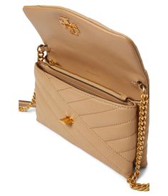 The Tory Burch Kira Chevron Chain Wallet brings luxe style wherever you go. Crafted from quilted leather with signature chevron patterns, this elegantly compact wallet fits essential cards and cash while its chain strap offers endless carrying options - wear crossbody for hands-free convenience or remove the strap to carry as a classic clutch. Gold-toned hardware bearing the iconic 'T' logo polish its look with timeless prestige. Inside, multiple pockets keep items organized, including a zippere Wallet With Chain, Tory Burch Kira Chevron, Kira Chevron, Tory Burch Kira, Chevron Patterns, Luxe Style, Compact Wallet, Chain Wallet, Tory Burch Bags