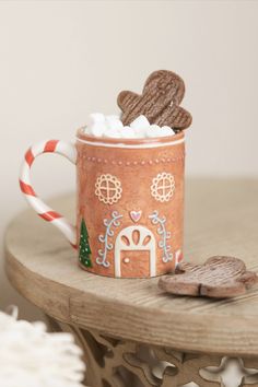 Get into the holiday spirit with our Gingerbread House Ceramic Mug. Featuring a charming gingerbread house design, this festive mug is perfect for enjoying your favorite seasonal beverages. Whether you're sipping hot cocoa, coffee, or tea, this delightful mug adds a touch of holiday cheer to your everyday routine. Christmas Coffee Cups Design, Gingerbread Mug, Christmas Pottery Painting, Cute Ceramic Mugs, Gingerbread House Designs, Hot Coco, Pottery Painting Designs, Winter Home Decor, Holiday Christmas Gifts