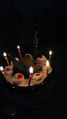 a birthday cake with lit candles on it