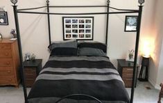 a bed with black and grey sheets in a bedroom