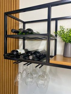 a shelf with wine glasses and bottles on it