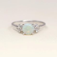 Natural Opal Engagement Ring Simple Opal with Side Diamond | Etsy Classic Opal Birthstone Ring With Round Band, Delicate Round Birthstone Ring For Anniversary, Dainty Round Couple Rings For Anniversary, Classic Round Cut Opal Birthstone Ring, Classic Opal Promise Ring With Birthstone, Classic Opal Birthstone Ring For Promise, Classic Opal Birthstone Promise Ring, White Round Diamond Ring Birthstone, White Round Diamond Birthstone Ring