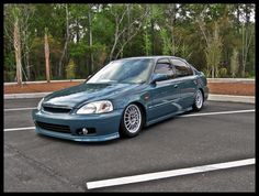 a blue car parked in a parking lot