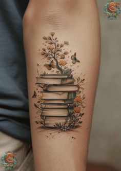 a woman's arm with a tattoo that has books on it and flowers growing out of the book