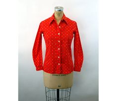 "This 1960s blouse is bright and fun! The fabric is a cotton rayon blend and has a small print - flowers and squares of different colors. Two button closure at the cuffs. Made by Toby Tanner. Very good condition. A fun retro look. Measurements - Shoulder - 14.5\" Bust - 36\" Waist - 34\" Length - 24\" from shoulder Sleeves - 22\" from shoulder * Proud member of the Vintage Fashion Guild * For more vintage fashions, visit Vintage Runways' shop at http://www.vintagerunway.etsy.com. Follow on Insta Retro Red Blouse For Spring, Fitted Cotton Blouse With Retro Print, Red Retro Print Shirt For Spring, Retro Red Shirt For Spring, Vintage Red Shirt For Spring, Long Sleeve Cotton Blouse With Retro Print, Cotton Retro Blouse With Retro Print, Retro Cotton Blouse With Retro Print, Retro Fitted Red Shirt