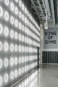 the king of gyms sign is projected on the wall