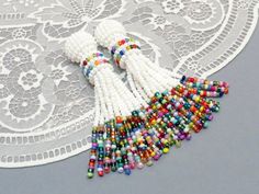 multicolored beaded tassels on white doily