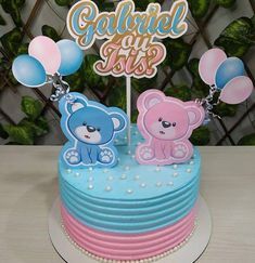 a blue and pink cake with two teddy bears on top that says, galnul at 1sts?