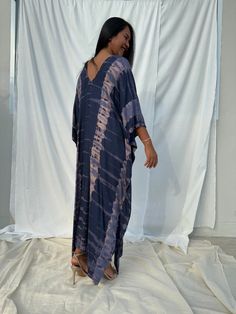 Dive into a world of vibrant color and unique patterns with our tie dye kaftan. Each piece is a masterpiece of individual hand tie-dyeing, ensuring that no two are alike. Crafted with meticulous care and attention, these kaftans offer a burst of style and creativity. Whether you're lounging at home, heading to the beach, or stepping out for an evening on the town, our tie dye kaftan is the perfect choice to make a bold and unforgettable fashion statement. Embrace the artistry and individuality o Beach Blue Batik Print Kimono, Blue Batik Print Beach Kimono, Bohemian Blue Kimono With Natural Dye, Blue Bohemian Kimono With Natural Dye, Blue Casual Kaftan With Batik Print, Casual Blue Kaftan With Batik Print, Casual Blue Batik Print Kaftan, Bohemian Hand Dyed Blue Dress, Hand Dyed Blue Bohemian Dress