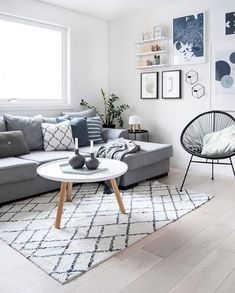 a living room filled with furniture and pictures on the wall