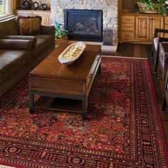 a living room filled with furniture and a fire place next to a couch in front of a fireplace