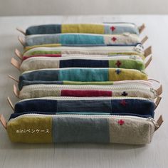 four zippered pouches lined up on a table