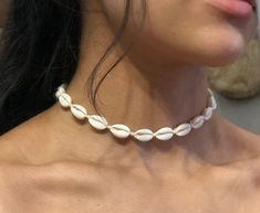 Handmade cowrie shell choker.  Adjustable (33-38cm) and made from cowrie shells on black or white waterproof cord.  Cowrie shells measure 17 x12 mm. 🌊 🏊✅ Pool & ocean proof.  📦✅ Shipped FREE in the UK and dispatched on the SAME DAY where possible. 🎁✅ Gift wrap option available.  Visit our Etsy site to view other Ben's Beach jewellery --> https://www.etsy.com/uk/shop/BensBeach 🌐 Visit our main site --> https://bensbeach.com/ to view our wider selection and subscribe for updates (we do not spam) re new jewellery and offers. Follow Ben on Instagram & Pinterest:  https://www.instagram.com/bensbeachjewellery/  https://www.pinterest.co.uk/6fccf3766a7720fb9faddadb150933/  See what other customers think of Ben's Beach by checking our reviews on Trust Pilot. https://uk.trustpilot.com/review/be Resizable White Jewelry For The Beach, Resizable White Jewelry For Beach, Resizable White Beach Jewelry, White Adjustable Shell For Beach, Adjustable White Shell For Beach, White Shell Jewelry For Beach Season, Adjustable White Cowrie Shell Necklace, White Adjustable Shell For Vacation, White Beaded Choker For Vacation