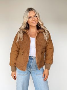 Stay warm and cozy in style with the Keep Toasty Teddy Jacket. This ultra-soft jacket features collared neckline, zipper closure, quilted puffer sleeves, and fuzzy teddy panels with pocket details for a trendy, elevated look. With a relaxed fit, it's perfect for football games, pumpkin patches, or hot cocoa by the fire. Experience the comfort and warmth of this luxurious jacket. Self 100% Polyester Contrast 100% Nylon Lining 100% Polyester Hand wash cold. Casual Puffer Jacket With Faux Fur Lining For Outdoor, Cozy Puffer Jacket For Cold Weather With Pockets, Casual Puffer Jacket With Faux Fur Trim For Outdoor, Trendy Sherpa Outerwear With Faux Fur Lining, Casual Long Sleeve Puffer Jacket With Faux Fur Trim, Cold Weather Sherpa Outerwear With Zipper Closure, Sherpa Outerwear With Zipper Closure For Cold Weather, Trendy Fleece Jacket With Pockets For Cold Weather, Casual Fall Puffer Jacket With Faux Fur Trim