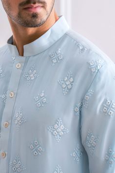 Editor's Note Featuring A Contemporary Lucknowi Powder Blue Nehru Jacket With Delicate Thread And Sequence Embroidery And Minimal Details. Perfect For An Outdoor Occcasion. This Comes With An Intricate Powder Blue Kurta With Mirror And Thread Work And Ivory Churidaar. Color: Powder Blue Fabric: Pure Georgette Care: Dry Clean Only About the Designer Ankit V Kapoor is a clothing brand that amalgamates traditional Indian handicrafts and bespoke tailoring. Inspired by the heritage of India and unifi Lucknowi Mens Kurta, Thread Work Kurta Men, Men Embroidery Kurta Design, Mens Kurta Embroidery Designs, Blue Kurta Men, Mirror Work Kurta For Men, Sikh Groom, Menswear Kurta