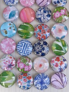 a bunch of different colored glass magnets on a table