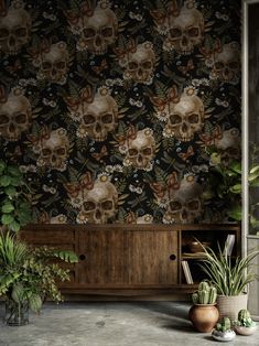 there is a wallpaper with skulls and flowers in the room next to plants on the floor