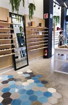 the inside of a store with shelves and plants