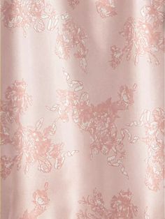 a pink shower curtain with white flowers on it