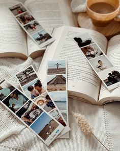 an open book sitting on top of a bed next to pictures and a coffee cup