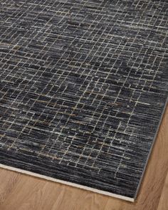 an area rug that has been placed on the floor in front of a wooden floor