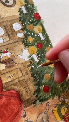 someone is painting a christmas tree with watercolors