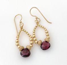 Quality handmade earrings in a lightweight design with 14K yellow gold filled beads and a faceted garnet dangle in the center.  Finished with 14K gold filled French ear wires.  Easy to wear, everyday style design.  Gold filled has the look of real gold without the expense. Nice gift that she can wear all year long.  Ready to ship and for gift giving! Details *Pretty faceted garnet accents *14K yellow gold filled beads smooth and stardust *14K yellow gold filled wire *14K yellow gold filled French ear wires *Measures 1 5/8" in total length x 1/2" across   *Ready to ship and sent in a gift box On the fence? Review my 5* feedback to see what my customers are saying. Explore more of my handmade jewelry designs here:  https://www.etsy.com/shop/jryendesigns Thank you for supporting handmade and Gold Garnet Teardrop Earrings, Gold Teardrop Garnet Earrings, Faceted Garnet Earrings In Gold, Gold Faceted Garnet Earrings, Gold Garnet Faceted Earrings, Gemstone Earrings Gold, Handmade Jewelry Designs, Garnet Earrings, Unique Handmade Jewelry