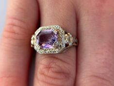 Size 5 1/2 with a 1.7 carat amethyst. Step into timeless elegance with this exquisite Vintage Filigree Amethyst Ring in 14K white gold. Crafted in an era where craftsmanship met artistry, this ring features a stunning unique cut amethyst that radiates a deep, captivating purple hue, perfectly complemented by intricate filigree detailing along the band. The 14K white gold setting not only enhances the rich color of the gemstone but also adds a touch of luxury and durability to this heirloom piece. Whether you're adding to your vintage jewelry collection or seeking a unique statement piece, this ring is sure to evoke admiration and envy alike. Don't miss the chance to own a piece of history and make it your own today. Luxury Lavender Amethyst Ring For Formal Occasions, Exquisite Yellow Gold Amethyst Ring With Accent Stones, Elegant Lavender Amethyst Ring In 14k Gold, Elegant Emerald Cut Amethyst Ring, Elegant Amethyst Wedding Ring, Elegant Wedding Amethyst Ring, Luxury Lavender Amethyst Ring For Anniversary, Formal Purple Platinum Rings, Fine Jewelry Purple Platinum Rings