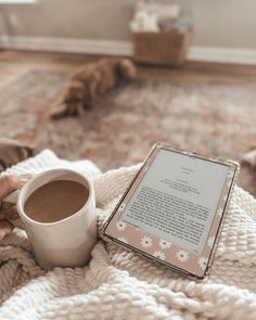 a person holding a cup of coffee while reading a book