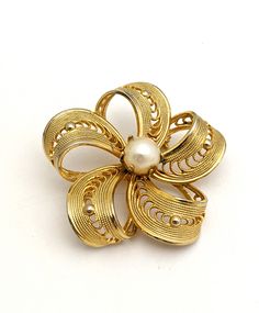 Vintage 60s small gold tone cut out filigree flower brooch with genuine freshwater pearl center. Ships USA, fast free shipping. Gift wrapping is available  Unsigned costume jewelry,  Pin measures 1.25" inches across No loss of gold tone Please see additional pics for more details and measurements Shipping includes tracking and insurance https://thejewelrycabinet.etsy.com www.instagram.com/thejewelrycabinet www.fb.com/thejewelrycabinet Elegant Gold Brooches For Spring, Vintage Spring Wedding Jewelry, Spring Gold Brooch Jewelry, Spring Gold Jewelry Brooch, Gold Brooch Jewelry For Spring, Spring Season Gold Brooch Jewelry, Gold Vintage Jewelry For Spring, Gold Brooches For Spring Gift, Spring Vintage Gold Jewelry