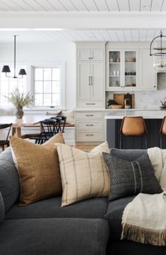 a living room filled with furniture and lots of pillows