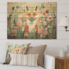 a living room scene with focus on the couch and wall art that has a fox painted on it