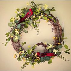 a wreath with flowers and birds on it