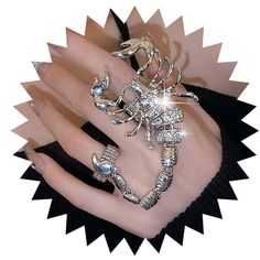 PRICES MAY VARY. Scorpion Finger Ring Bracelet is easy to adjust and would fit fingers size US 4 and up. Punk Hand Chains Harness has carefully crafted, features intricately designed scorpion-inspired rings connected by delicate tassel chains. The vintage punk aesthetic is enhanced by the addition of gothic crystal accents, creating a mesmerizing and edgy look. Rhinestone Hand Bracelets ideal for couples or anyone with a taste for distinctive jewelry, this set makes a statement that is both dari Vintage Punk Aesthetic, Scorpion Aesthetic, Finger Ring Bracelet, Hand Bracelets, Full Finger Ring, Chain Harness, Hand Harness, Full Finger Rings, Bracelets Adjustable