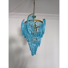 a blue chandelier hanging from the ceiling in a room with white walls and flooring