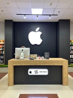 an apple store front desk with the apple logo on it