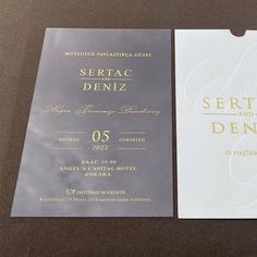 two white and gold wedding cards on top of each other with the word sertac deniz printed on them