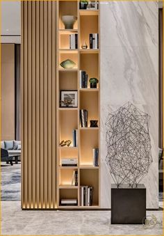 a book shelf with many books on it in the middle of an office lobby area