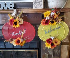 two sunflowers are hanging from the front of a fire place with thank you written on them