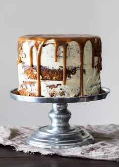 a cake with white frosting and caramel drizzled on the top