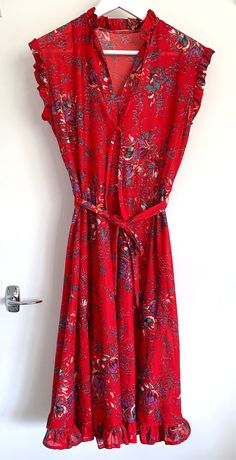 A cute brightly printed floral ruffle dress, in an electric red colour, with energetic floral motifs. Made of polyester so has a 70s/80s vibe to it. But I think it could be styled in a really fresh way with some white trainers and a denim jacket.  Great Condition and badly modelled by myself! Red Fitted Printed Floral Dress, Red Printed Fitted Floral Dress, Fitted Red Floral Printed Dress, Fitted Red Printed Floral Dress, Red Printed Floral Dress For Spring, Vibrant Red Printed Dress, Red Bohemian Floral Dress For Spring, Bohemian Red Floral Dress For Spring, Red Retro Dress For Spring