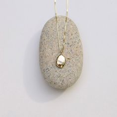 Wishing Stone Necklace, Gold Pebble Necklace, Diamond Pebble Pendant, Gold Diamond Charm, Solid Gold Pebble Necklace They say a pebble with a continuous white line around it is a wishing stone that can grant your deepest desire. This is not that stone. This gold and diamond pebble stands for something more empowering: You can grant your deepest desire. No matter how impossibly big your dream may seem, at its heart is something entirely within reach: the freedom of becoming who you most want to b White Gold Pendant Necklaces With Stones, Diamond White Necklaces With Stones For Anniversary, 14k Gold Yellow Gold Necklace With Stones, Diamond White Necklace With Stones For Anniversary, Diamond White Anniversary Necklace With Stones, Luxury Diamond Necklace As Gift, Oval Necklace With Single Cut Diamonds For Gift, Oval Single Cut Diamond Necklaces As Gift, Oval Single Cut Diamond Necklaces For Gifts