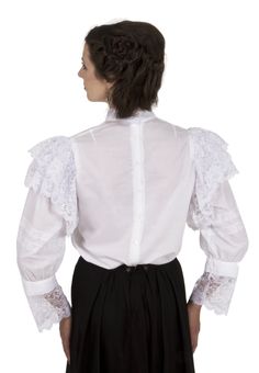 Delight both you and your friends when you wear this charming white batiste Edwardian blouse! Styled from about 1909, this classic blouse is eye-catching! This blouse has a white triple ruffled jabot at the center front and a lovely high lacy collar. Beautiful white lace ruffles are atop lace adorned gathered sleeves. The blouse has back button closure.Machine or hand wash cold. Tumble dry low. The white batiste is 100% cotton. Poly lace. The model is wearing a skirt and a cameo which are both p Edwardian Blouse, Classic Blouse, Classic Blouses, Gathered Sleeves, Lace Ruffle, Womens Clothing Tops, White Lace, Ruffles, Ruffle Blouse