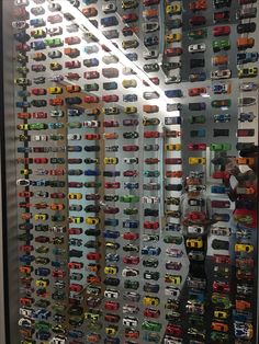 a display case filled with lots of toy cars