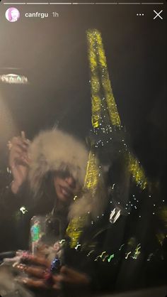 two people sitting at a table in front of the eiffel tower