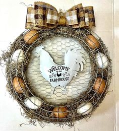 a wreath with an image of a chicken and eggs in the center is hanging on a wall