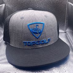 Top Golf Snapback Hat With Mesh Back. Excellent Condition. Never Worn. Gray Flat Brim Trucker Hat For Sports, Blue Six-panel Trucker Hat For Sports Events, Gray Snapback Hat For Sports Events, Gray Flat Bill Trucker Hat For Sports, Gray Snapback Hat With Flat Bill, Sporty Style, Gray Sporty Snapback Hat With Flat Bill, Gray Sporty Snapback Trucker Hat, Sporty Gray Snapback Hat With Flat Bill, Sporty Gray Snapback Trucker Hat